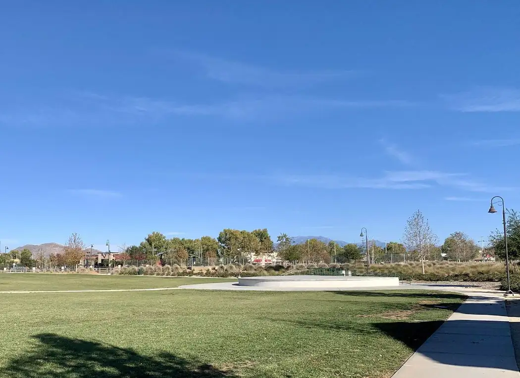 Open lawn and pond at Central Park in Menifee, California