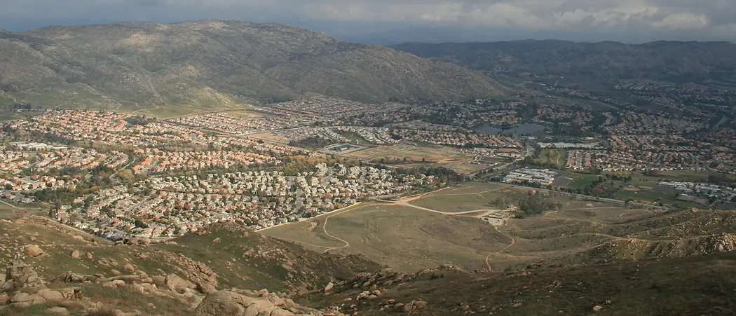 View across Moreno Valley, California, with neighborhoods spreading up the hillside toward Box Springs Mountain
