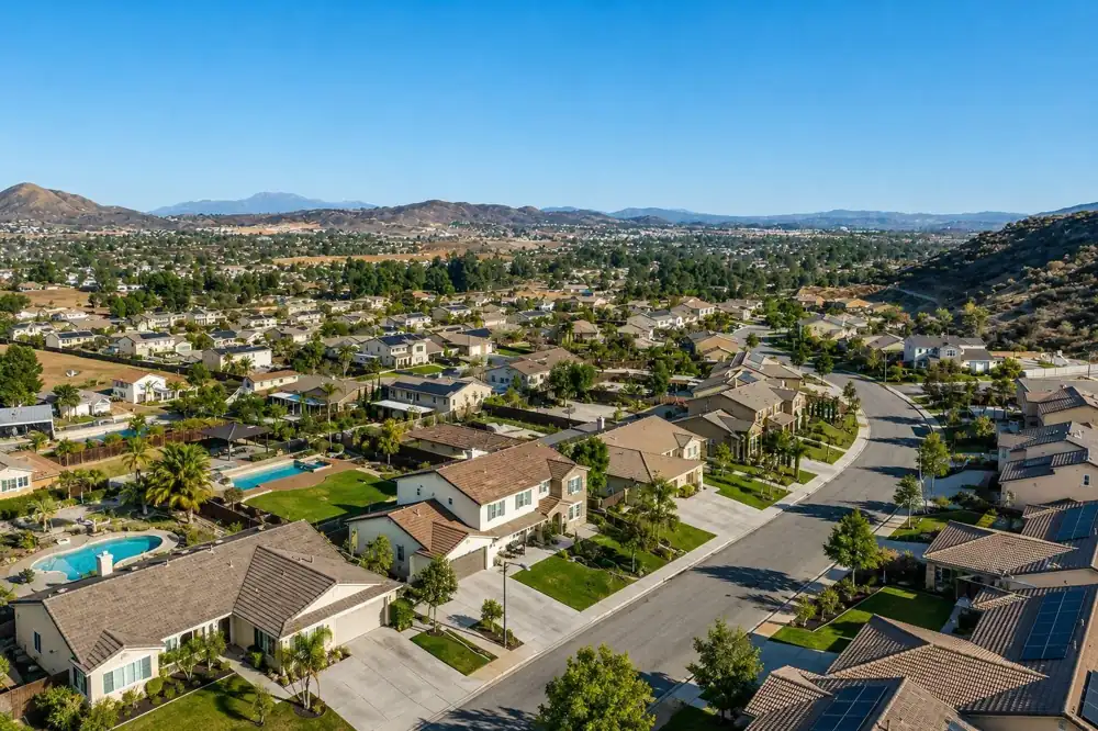 Aerial view of a Southern California neighborhood of single-family homes with backyard pools